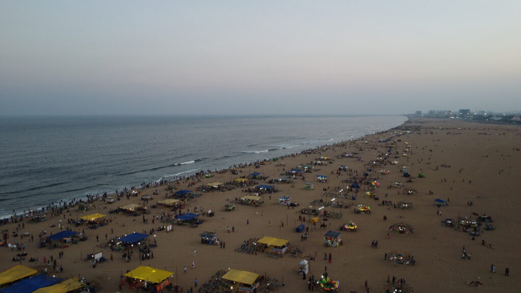 Busy Marina Beach in the Evening with numerous lit stalls