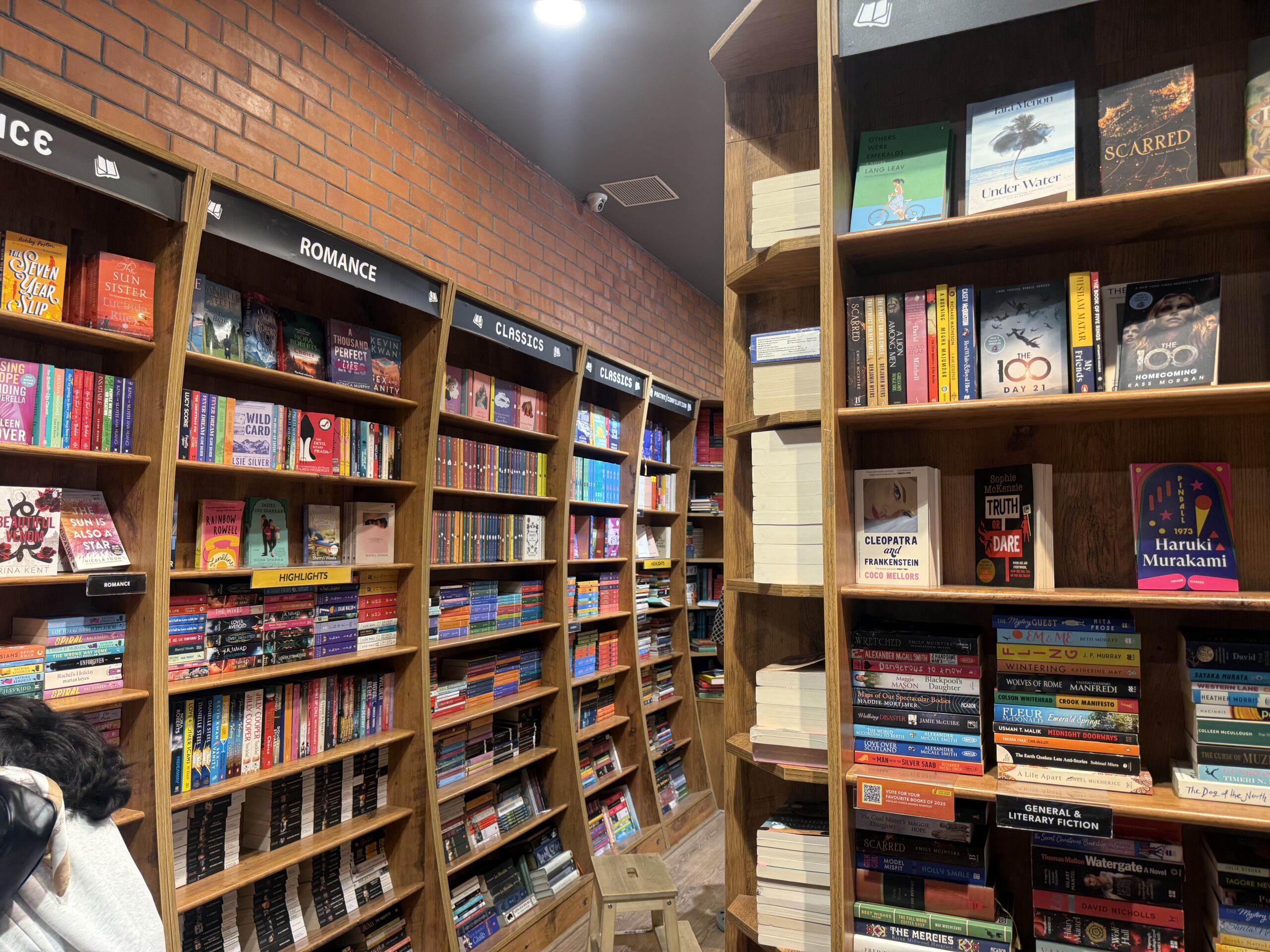 Bookshelves featuring fiction titles at Crossword Bookstore Chennai